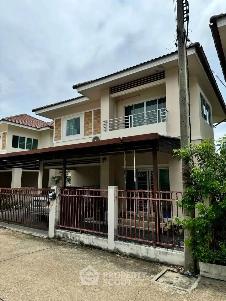 Charming two-story house with modern design and spacious balcony in a serene neighborhood.