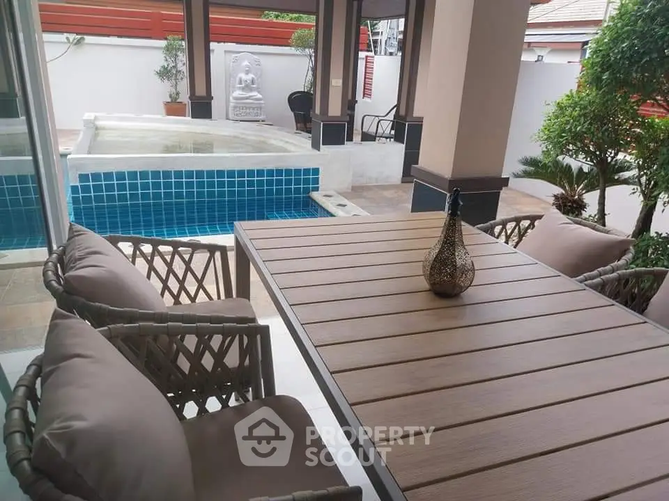 Elegant outdoor patio with pool and stylish furniture in serene setting