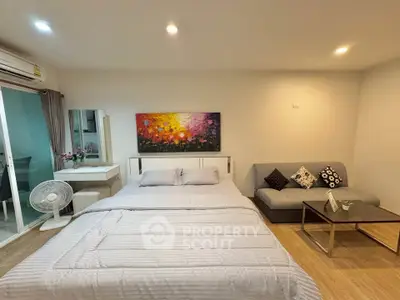 Cozy bedroom with modern decor and comfortable seating area