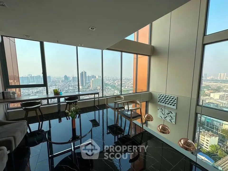 Stunning high-rise living room with panoramic city views and modern decor.