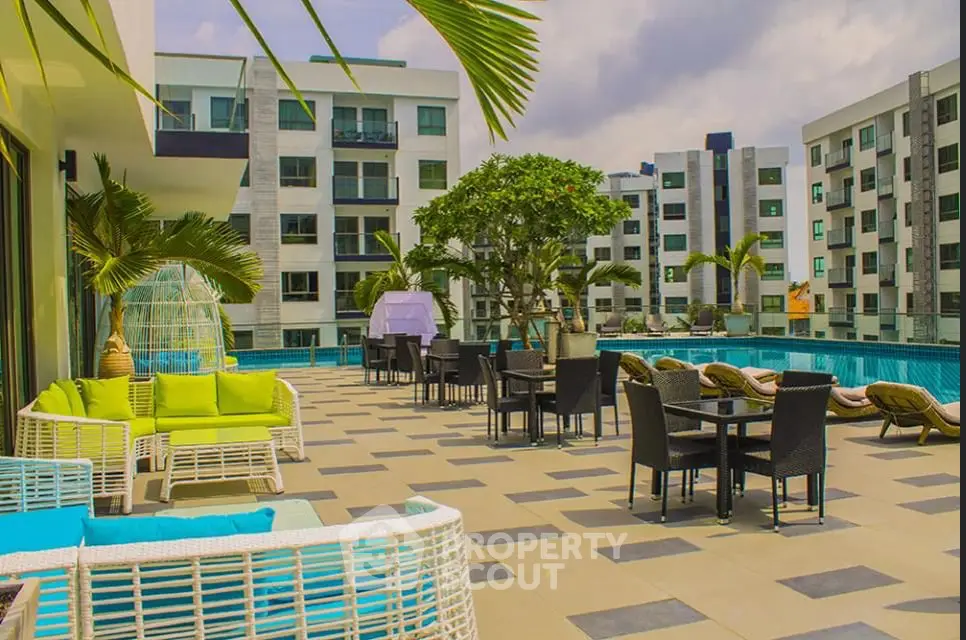 Luxurious rooftop pool area with modern seating and stunning city views.