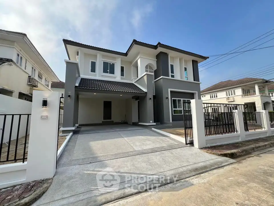 Modern two-story house with spacious driveway and elegant facade in suburban neighborhood