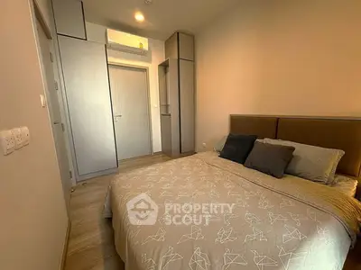 Cozy bedroom with modern design and ample storage in a stylish apartment.