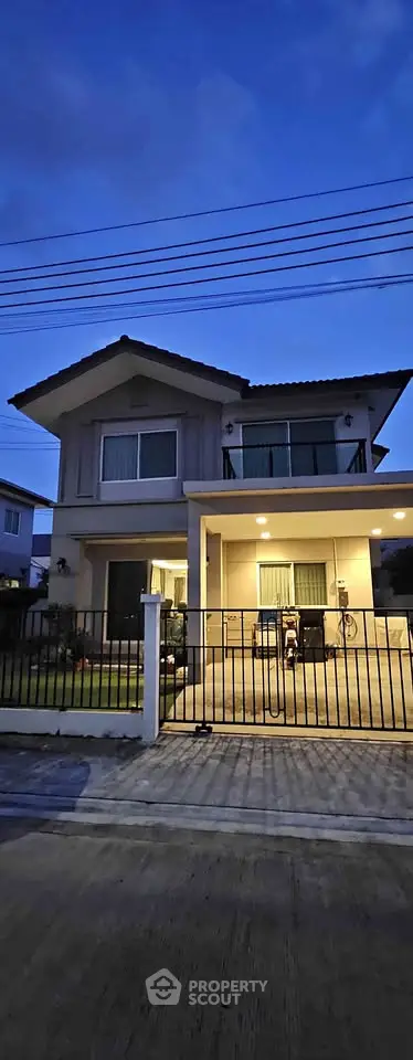 Charming two-story house with modern design and spacious front yard, perfect for family living.