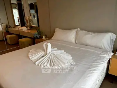 Luxurious bedroom with elegant decor and plush bedding in a modern apartment.