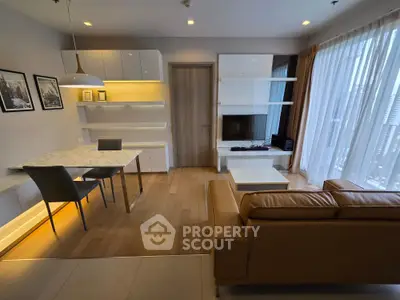 Modern living room with stylish furniture and large windows offering city views.