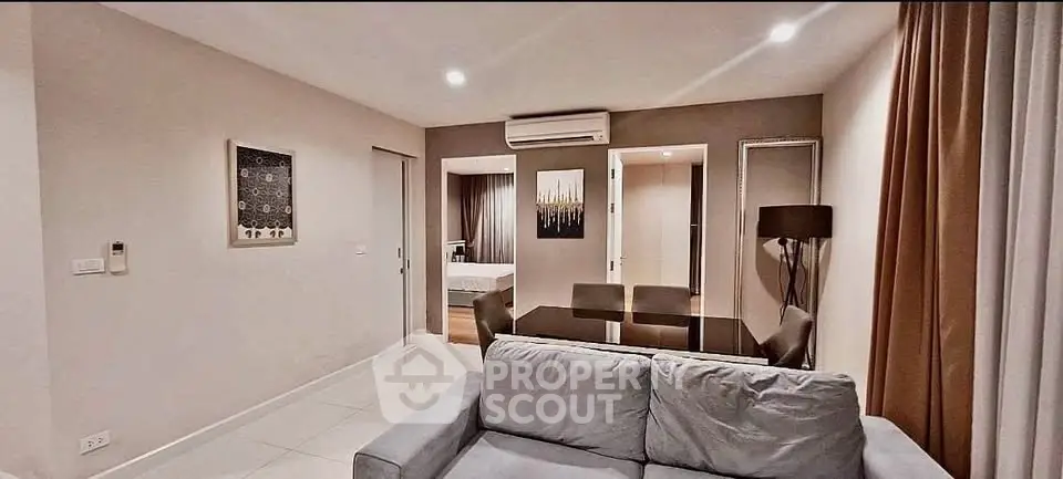 Modern living room with cozy sofa and dining area in stylish apartment