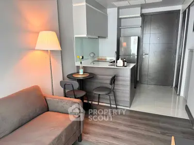 Modern studio apartment with cozy living area and compact kitchen, perfect for urban living.