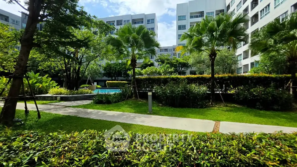 Lush garden view in modern residential complex with pool and greenery