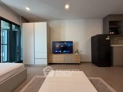 Modern living room with sleek furniture and large TV, perfect for relaxation and entertainment.