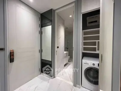 Modern bathroom with washing machine and sleek storage solutions