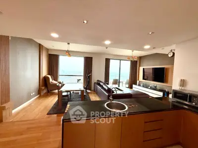 Luxurious open-plan living room with stunning city view and modern furnishings.