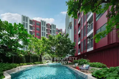 Luxurious condominium with stunning pool and lush greenery, perfect for modern living.