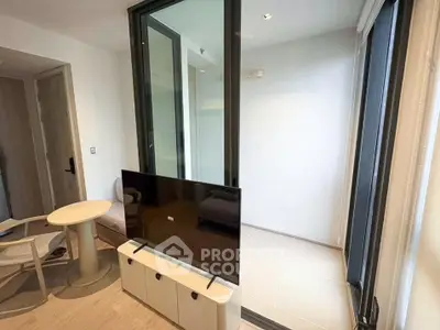 Modern living room with sleek TV setup and stylish furniture in a contemporary apartment.
