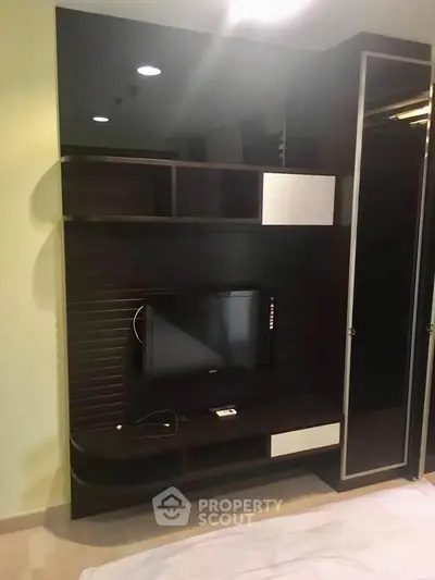 Modern living room with sleek TV unit and storage cabinets, perfect for stylish urban living.