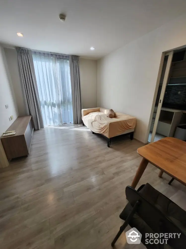 Modern minimalist bedroom with wooden flooring and natural light