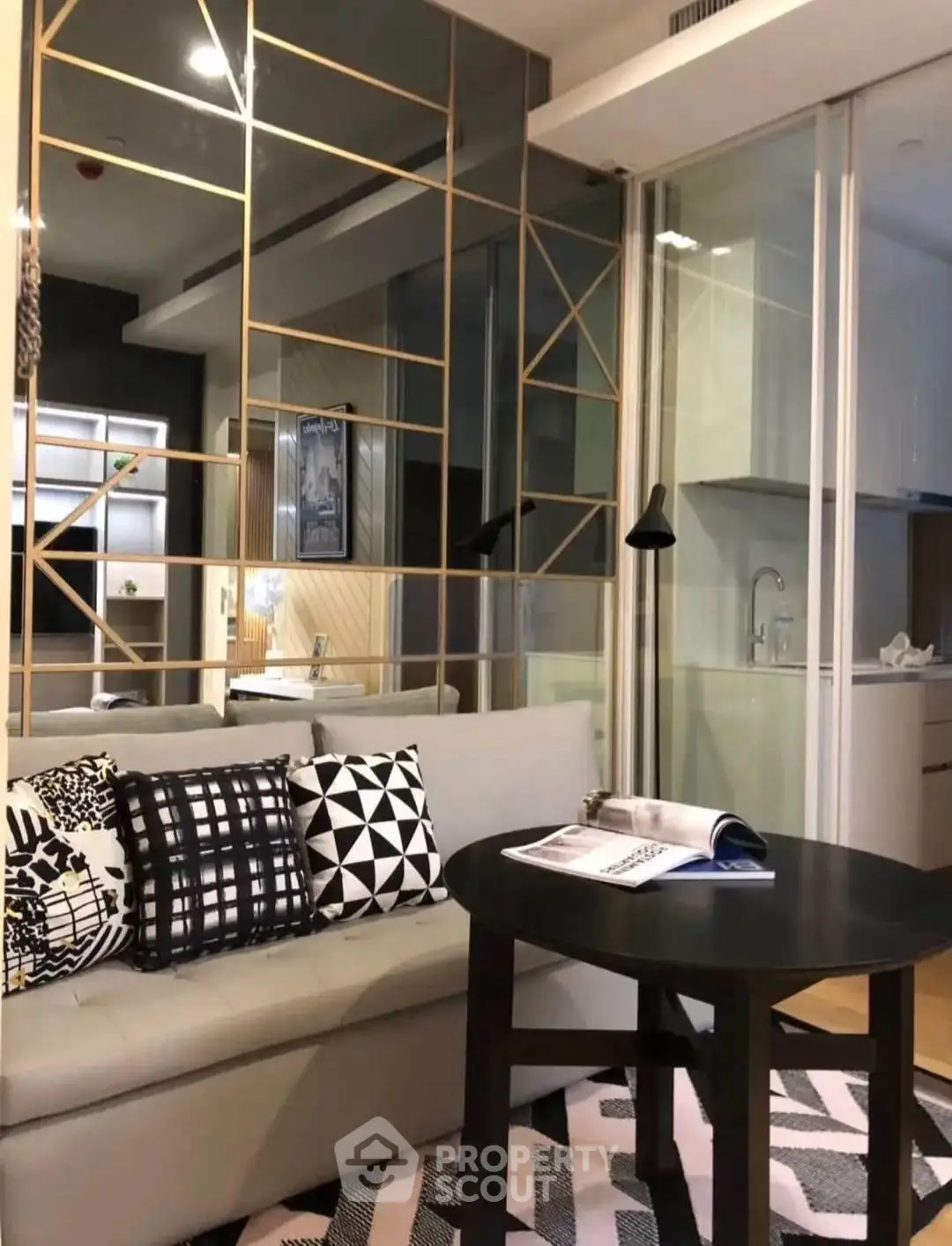 Stylish modern living room with geometric decor and open kitchen layout