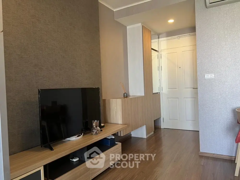 Modern living room with stylish TV stand and wooden flooring