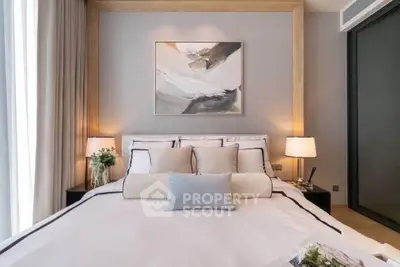 Luxurious bedroom with modern decor and elegant lighting, featuring a cozy bed and stylish artwork.
