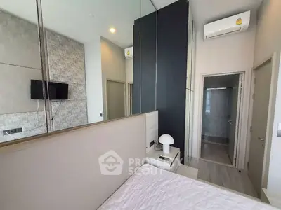 Modern bedroom with sleek design, featuring a wall-mounted TV and air conditioning for ultimate comfort.