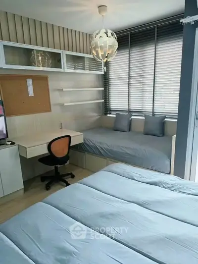 Modern bedroom with study area, featuring sleek design and ample natural light.