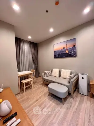 Modern living room with stylish furniture and cityscape artwork, featuring cozy seating and elegant decor.