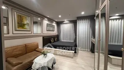 Modern bedroom with elegant decor, featuring a cozy bed, stylish sofa, and chic artwork, perfect for relaxation.