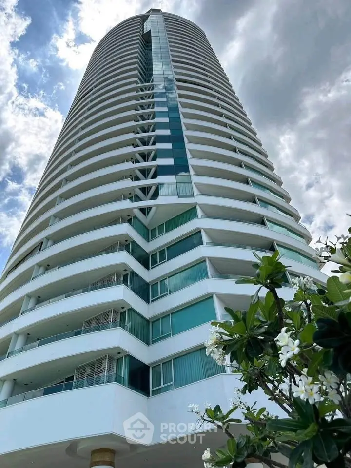 Stunning modern high-rise building with unique architectural design and lush greenery.