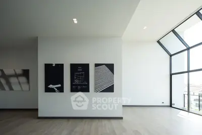 Spacious modern living room with large windows and minimalist decor