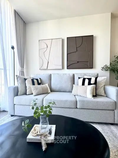 Modern living room with stylish decor and comfortable gray sofa, perfect for relaxation.