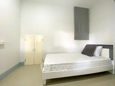Spacious minimalist bedroom with modern bed and ample storage space