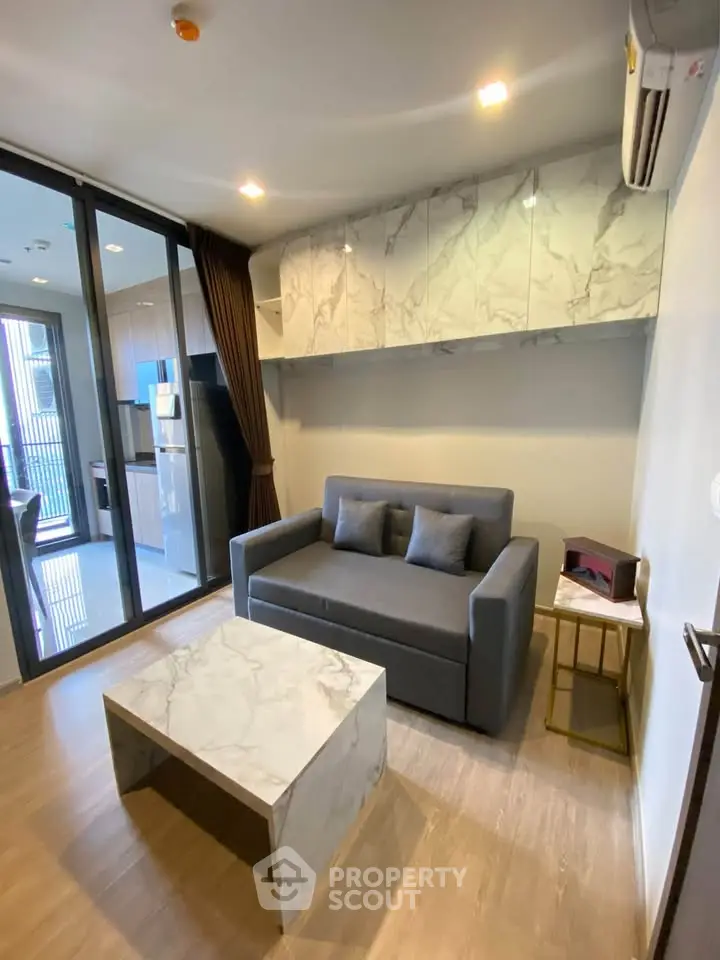 Modern living room with marble accents and cozy sofa in stylish apartment