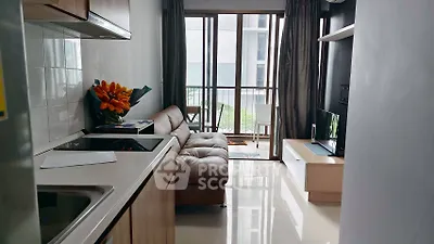 Modern compact living room with sleek kitchen and balcony view