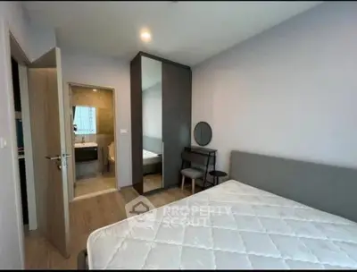 Modern bedroom with ensuite bathroom and stylish furniture in a contemporary apartment.