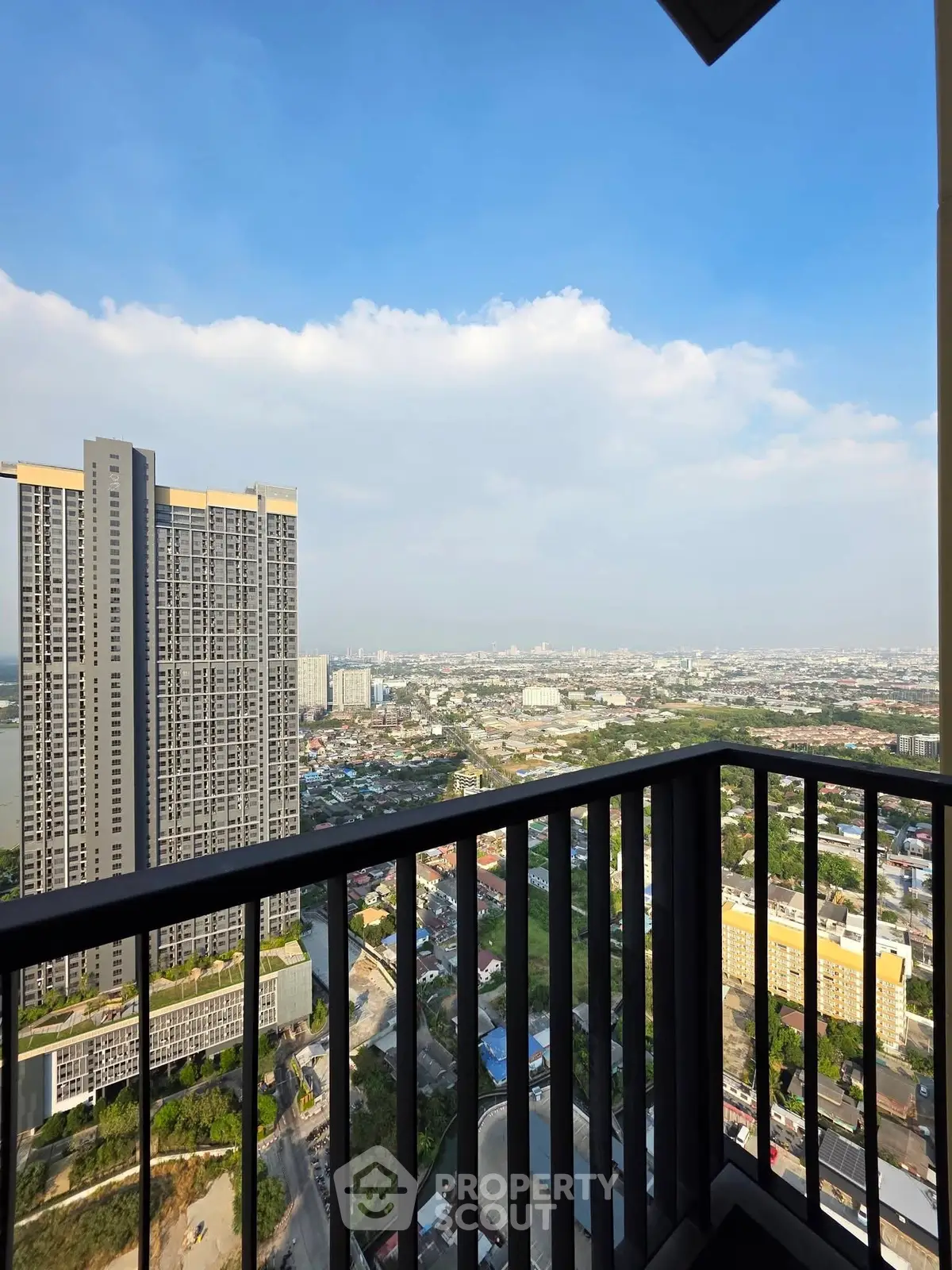 Stunning high-rise balcony view overlooking cityscape and skyline, perfect for urban living enthusiasts.