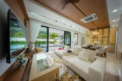 Luxurious open-plan living room with pool view and elegant decor