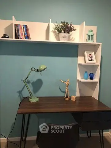 Modern study room with stylish desk and wall shelves, perfect for productivity and organization.