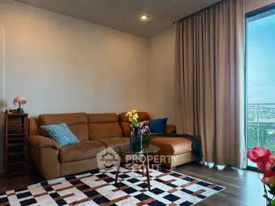 Spacious living room with modern decor and large window offering city views.