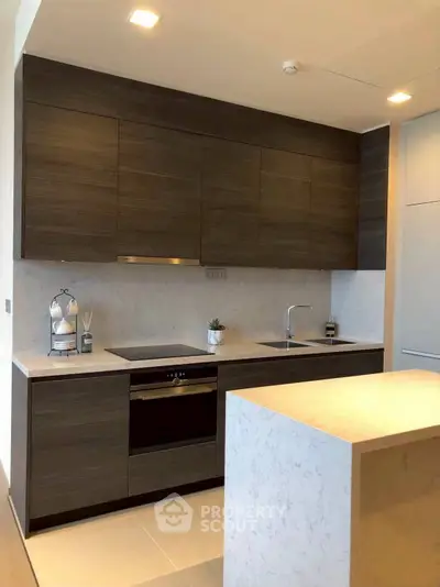 Modern kitchen with sleek dark wood cabinets and marble countertops