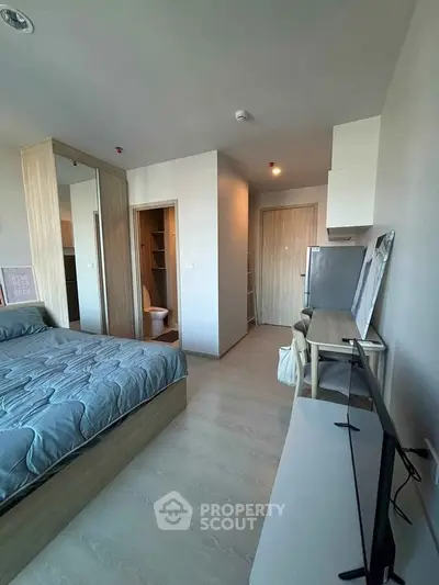 Modern bedroom with ensuite bathroom and sleek furnishings in a stylish apartment.