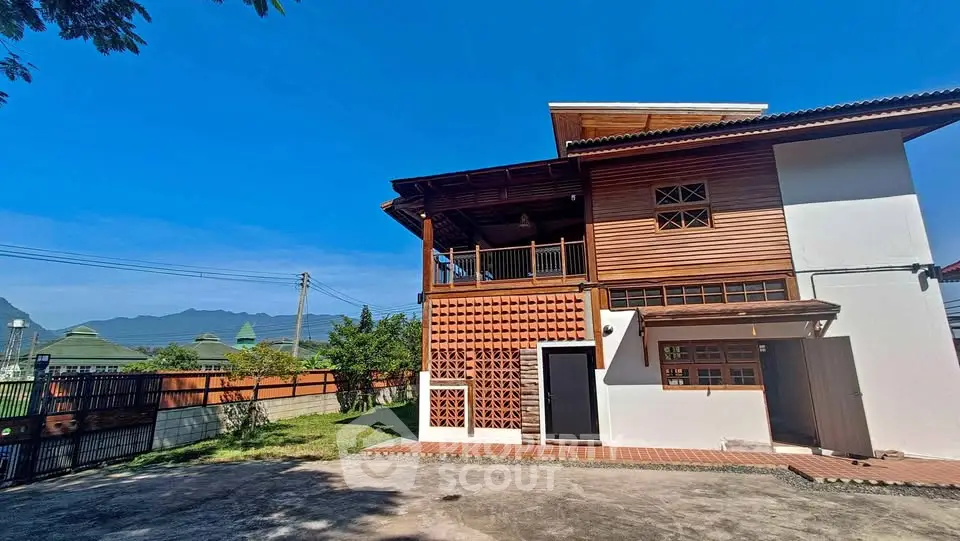 Charming two-story wooden house with spacious yard and mountain views.