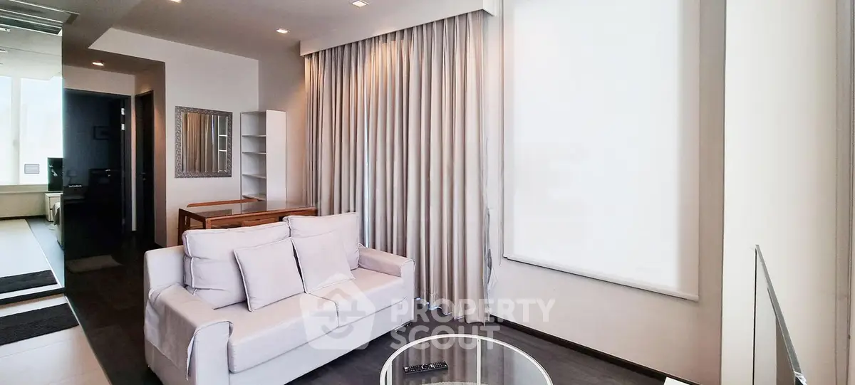 Modern living room with sleek design and large windows for natural light.