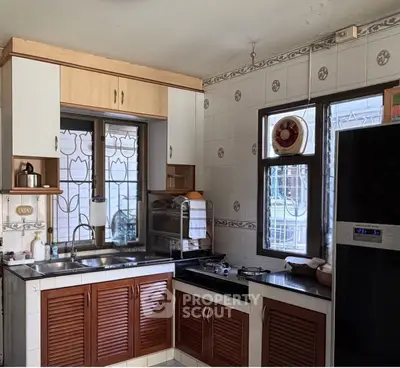 Charming kitchen with closed layout, featuring modern appliances and ample natural light.