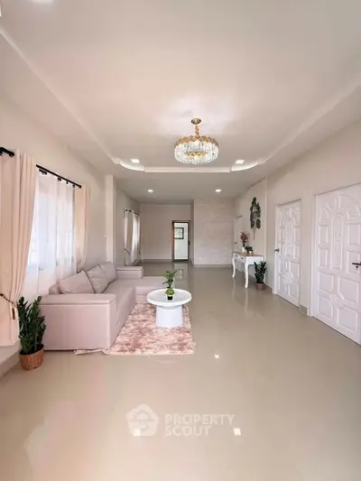 Spacious and elegant living room with modern decor and chandelier lighting