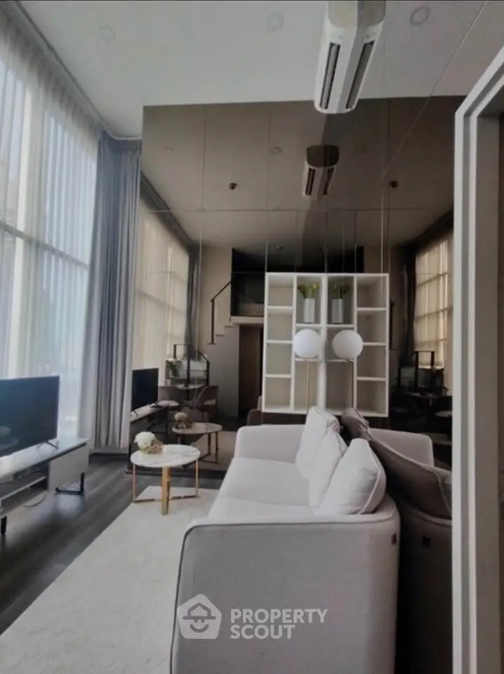 Luxurious modern living room with high ceilings and elegant decor