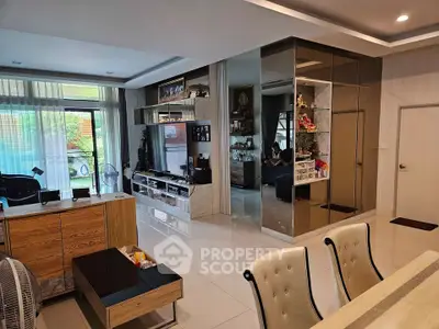 Spacious modern living room with elegant decor and large windows offering natural light.