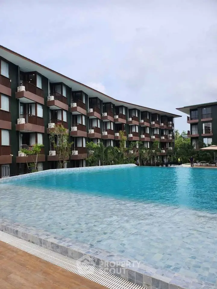 Luxurious apartment complex with stunning pool and modern architecture.