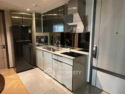 Modern kitchen with sleek cabinetry and integrated appliances in a stylish apartment.
