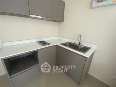 Modern minimalist kitchen with sleek cabinetry and built-in stove