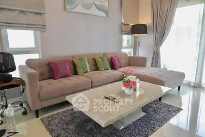 Stylish living room with modern sofa, elegant decor, and natural light
